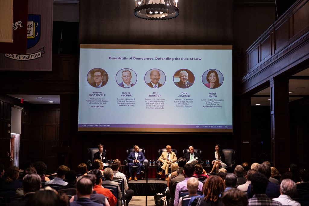 Panelists on the first panel of the day — "Guardrails of Democracy: Defending the Rule of Law" — speak in front of an audience.