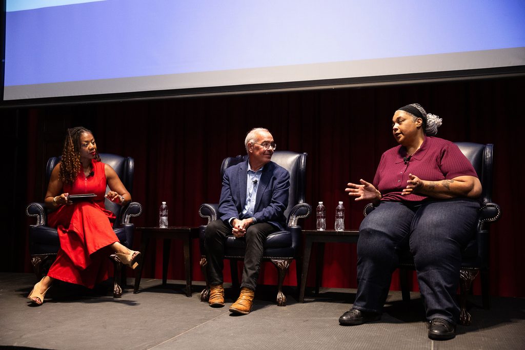 Roxane Gay speaks during the plenary keynote as David Brooks and moderator Cherri Gregg listen.