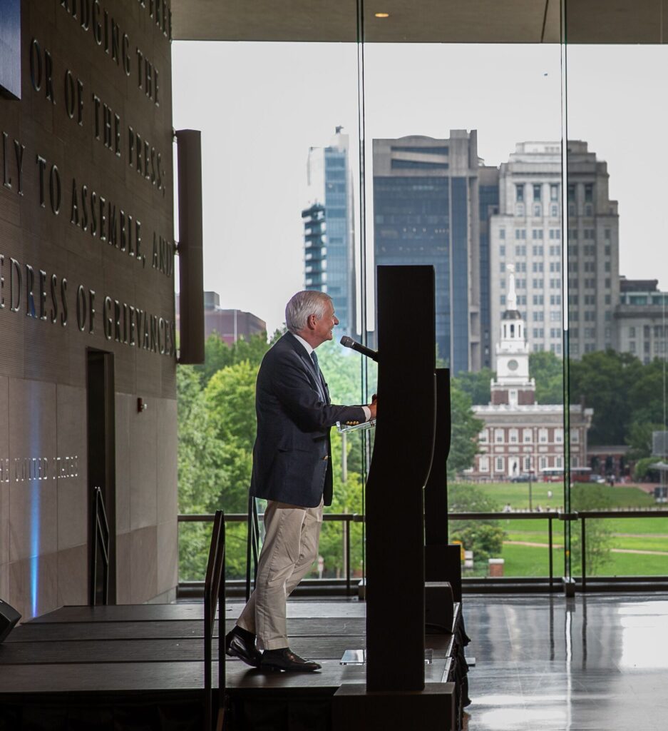Historian Jon Meacham delivers a keynote with Independence Mall in the background.